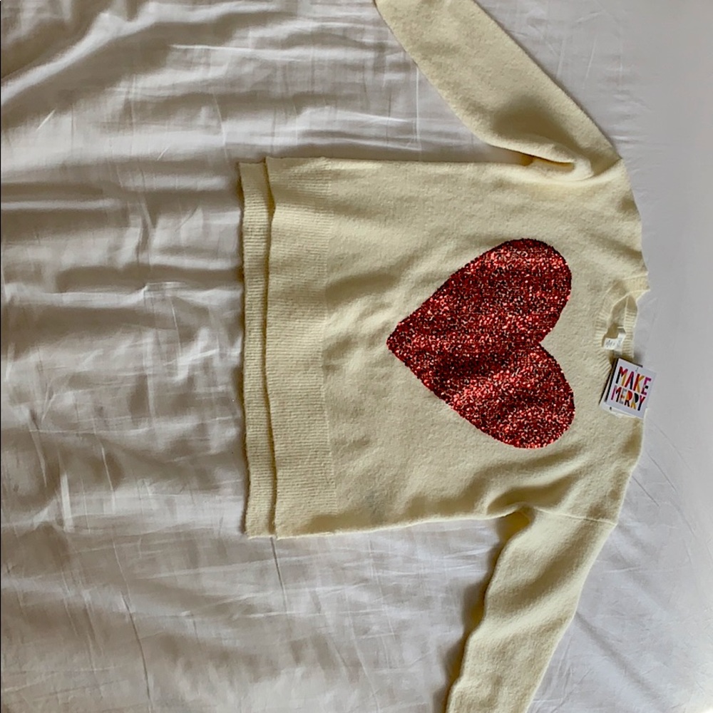 It is a very soft cardigan with a big red heart.